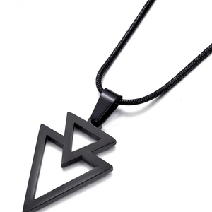 Macro shot of minimalist black overlapping geometric triangle pendant on snake chain