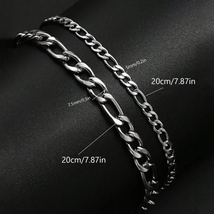 Silver Figaro chains in 5mm and 7.5mm widths on black leather texture background