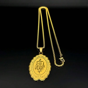 Gold oval pendant necklace with Allah calligraphy on beaded chain against black backdrop