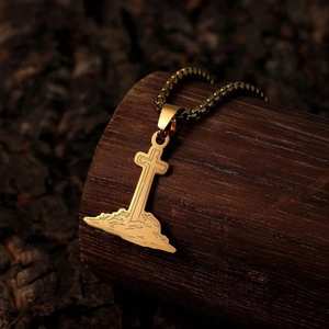 Vintage gold stainless steel cross pendant necklace with box chain on wood texture