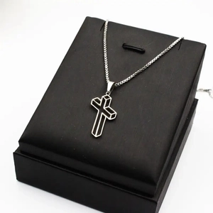 Sleek 3D geometric stainless steel cross pendant necklace on a premium black box