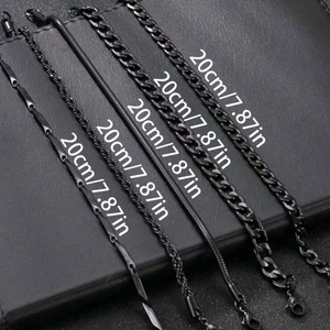 Close-up of five black plated metal chains including Cuban, snake, and rope styles