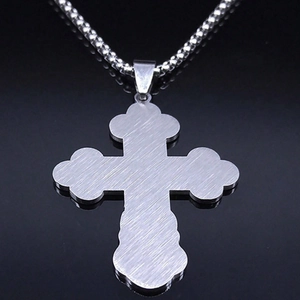 Detail view showing brushed stainless steel texture on the back of the cross pendant