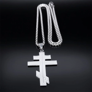 Detailed silver Orthodox cross necklace with etched lines on black mirror background