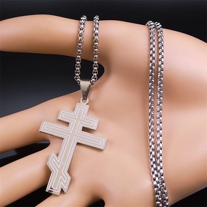 Silver Orthodox cross pendant with box chain on hand model against black background