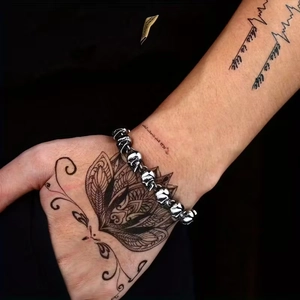 Close-up of punk style silver skull head bracelet with detailed gothic metal craftsmanship