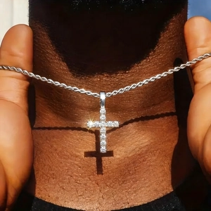 Icy silver cross necklace with pavé crystals on a thick rope chain, worn on neck