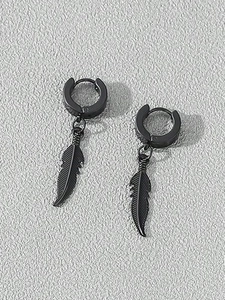 Detail of matte black feather earrings with intricate textures and gothic styling