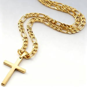 Macro view of golden stainless steel cross pendant featuring a classic Figaro chain