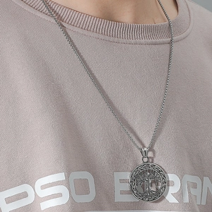Detailed view of Celtic Tree of Life pendant with silver box chain on model