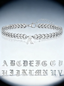 Detail of silver Cuban chain bracelet with Gothic alphabet charms and lobster clasp