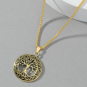 Macro shot of gold Tree of Life pendant featuring intricate Celtic knot patterns on box chain