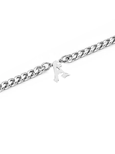 Macro detail of silver stainless steel Cuban link chain with vintage letter A pendant