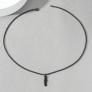 Men's matte black feather pendant necklace set with square link chain on grey background