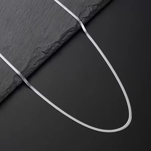Macro detail of high-quality polished silver flat snake chain jewelry set close-up view