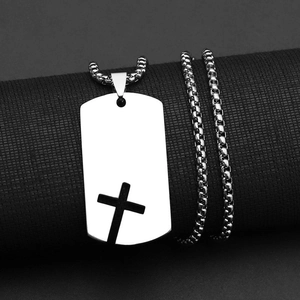 Detail showing silver stainless steel cross cutout pendant with square box chain