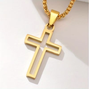 Macro shot of 18K gold hollow cross pendant with elegant box chain on white background