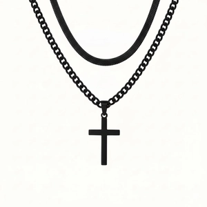 Layered black stainless steel necklace featuring a snake chain and cuban link with cross