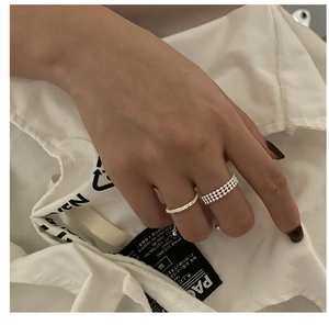 Detail view of stacked S925 sterling silver beaded rings with a polished finish