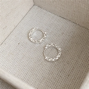 Sparkling S925 sterling silver hoop earrings with diamond-cut texture on display