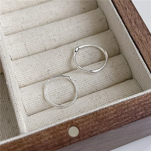 Detail of two S925 sterling silver rings with irregular texture in a jewelry box