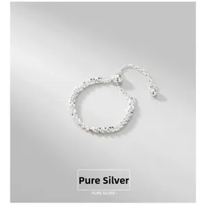 Detail showing the adjustable pure silver chain ring with beaded tassel design