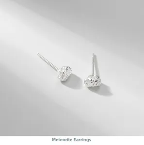 Macro shot of silver meteorite stud earrings with unique irregular foil texture