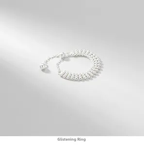 Close-up of S925 sterling silver triple-layer beaded chain ring with a dangling charm