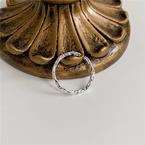 Macro shot of silver textured open ring with crinkled foil effect on a vintage base