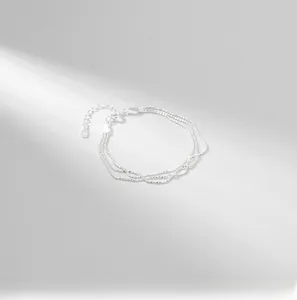 Close-up of a three-layer S925 sterling silver beaded bracelet with lobster clasp