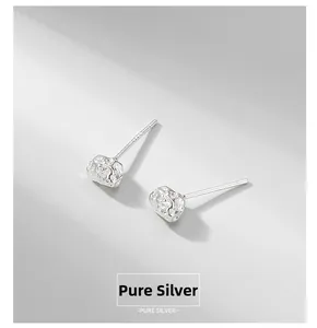 Macro detail of S925 sterling silver stud earrings with irregular meteorite texture finish