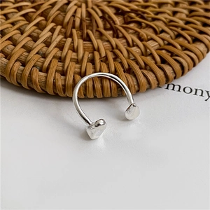 Macro shot of U-shaped S925 sterling silver open ring with polished metallic finish