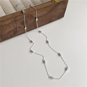 Sparkling S925 sterling silver clavicle chain with faceted metal beads on dark wood box