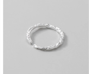 Macro shot of S925 sterling silver ring with textured foil finish and lava-like surface