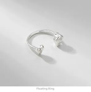 Detailed view of S925 sterling silver floating ring with irregular textured pebble tips