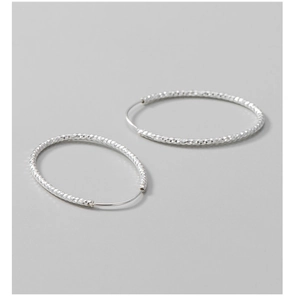Detailed close-up of S925 sterling silver hoop earrings with a diamond-cut textured finish