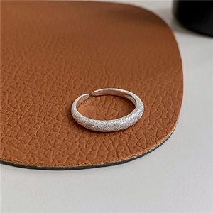 Detailed macro shot of S925 sterling silver stamp and frosted texture on open ring band