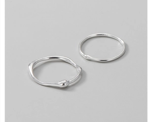 Macro detail of S925 sterling silver rings with irregular liquid texture and organic shape