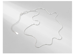 Detail of S925 sterling silver beaded chain with square cut segments and lobster clasp