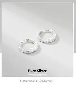 Detailed close-up of glitter-finished S925 sterling silver round hoop earrings
