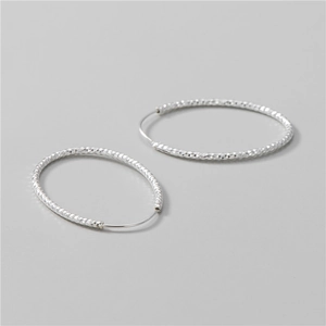 Diamond-cut S925 sterling silver hoop earrings with a sparkling faceted surface