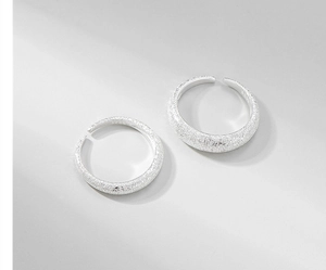 Close-up of sparkling S925 sterling silver open rings with frosted starlight texture