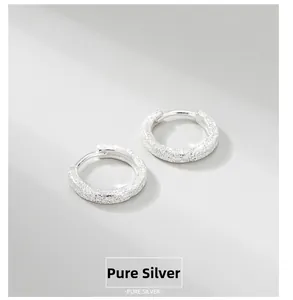 Close-up of frosted S925 sterling silver hoop earrings with sandblasted finish texture