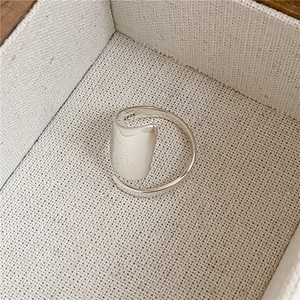 Macro view of S925 sterling silver ring showing brushed shield surface and purity stamp
