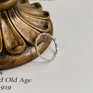 Slim S925 sterling silver ring with handcrafted hammered texture on a vintage background