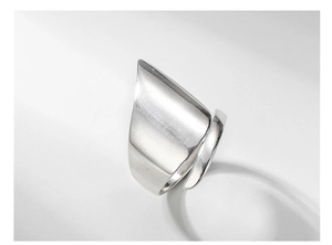 Close-up of a minimalist wide S925 sterling silver ring with polished geometric angles