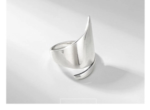 Detail shot of a polished S925 sterling silver wide band ring with minimalist irregular shape