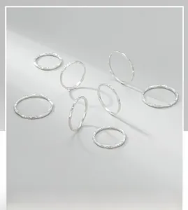 Detailed view of seven S925 sterling silver rings with hammered texture and minimalist style