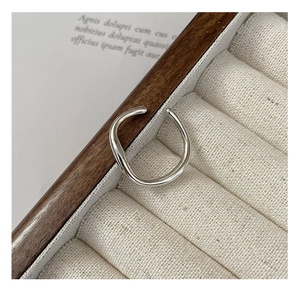 Macro detail of S925 sterling silver irregular liquid stream ring in velvet box