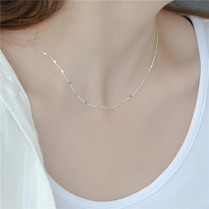 Minimalist S925 sterling silver shimmering disk necklace worn on a woman neck